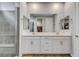 Modern bathroom featuring double vanity, large mirrors, and tiled walk-in shower at 2115 Noble Perch St, Las Vegas, NV 89138