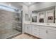 Modern bathroom featuring double vanity and frameless glass shower with a built-in seat at 2115 Noble Perch St, Las Vegas, NV 89138