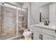 Modern bathroom featuring a glass shower with decorative tile and a white vanity with black hardware at 2115 Noble Perch St, Las Vegas, NV 89138