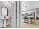 View from the powder room into the kitchen with stainless appliances and pendant lighting at 2115 Noble Perch St, Las Vegas, NV 89138