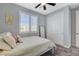 Cozy bedroom featuring neutral colors, a ceiling fan, and natural light from the window at 2115 Noble Perch St, Las Vegas, NV 89138