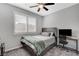 Cozy bedroom with a ceiling fan, shuttered window, carpet, and a dark wood-colored bed and desk at 2115 Noble Perch St, Las Vegas, NV 89138