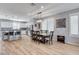 Bright dining area features a rectangular chandelier over a table for eight with a view of the kitchen at 2115 Noble Perch St, Las Vegas, NV 89138