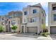 Contemporary gray home in a row of similar style houses with landscaping at 2115 Noble Perch St, Las Vegas, NV 89138