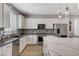 This kitchen features stainless steel appliances, modern lighting, an island, and decorative backsplash at 2115 Noble Perch St, Las Vegas, NV 89138