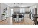 Gourmet kitchen features an island with counter seating, modern appliances, and a decorative backsplash at 2115 Noble Perch St, Las Vegas, NV 89138