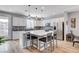 Gourmet kitchen features an island with counter seating, modern appliances, and a decorative backsplash at 2115 Noble Perch St, Las Vegas, NV 89138