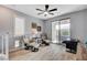 Living area featuring tile floors, ceiling fan, seating, and natural light from the sliding glass doors at 2115 Noble Perch St, Las Vegas, NV 89138