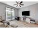 Living room with tile floors, ceiling fan, and sliding glass doors to the outdoor patio at 2115 Noble Perch St, Las Vegas, NV 89138