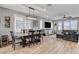 The living room and dining area features recessed lighting, ceiling fan, wood floors and a cozy gray couch at 2115 Noble Perch St, Las Vegas, NV 89138