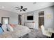 Bright main bedroom featuring a ceiling fan, plush carpet, and an ensuite bathroom at 2115 Noble Perch St, Las Vegas, NV 89138