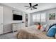Bright main bedroom with a TV, ceiling fan, and view of the bathroom at 2115 Noble Perch St, Las Vegas, NV 89138