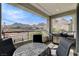 Outdoor patio with table, chairs, and grill overlooking scenic mountain views and construction at 2115 Noble Perch St, Las Vegas, NV 89138