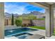 Private pool features a spa and waterfall surrounded by landscaping, set against mountain views at 2115 Noble Perch St, Las Vegas, NV 89138