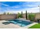 Inviting backyard pool with waterfall feature and ample patio space for outdoor entertaining at 2115 Noble Perch St, Las Vegas, NV 89138