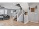 Carpeted staircase with white railing leads to the upper and lower levels of this light and airy home at 2115 Noble Perch St, Las Vegas, NV 89138