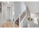 Open staircase with plush carpet, white railings, and tile flooring landing at 2115 Noble Perch St, Las Vegas, NV 89138