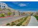 Community street featuring modern homes, landscaped sidewalks, and mountain views in a vibrant setting at 2115 Noble Perch St, Las Vegas, NV 89138