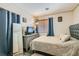 Cozy bedroom with soft lighting, blue accents, and a comfortable bed with a cushioned headboard at 2301 Cambridge Elms St, North Las Vegas, NV 89032