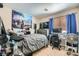 Relaxed bedroom with a large mural, a gray bedspread, and a modern fan at 2301 Cambridge Elms St, North Las Vegas, NV 89032