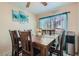 Inviting dining room featuring a wooden table set, natural light, and decorative wall art for a cozy meal setting at 2301 Cambridge Elms St, North Las Vegas, NV 89032