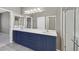 This bathroom features double sinks, a glass shower, and bright vanity lighting at 2525 Willow Wren Dr, North Las Vegas, NV 89084