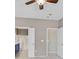 This bedroom features neutral colors with the primary bathroom visible beyond the doorways at 2525 Willow Wren Dr, North Las Vegas, NV 89084