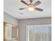 This bedroom showcases a decorative ceiling fan and natural light from shuttered windows at 2525 Willow Wren Dr, North Las Vegas, NV 89084