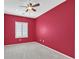 This empty bedroom features a ceiling fan and natural light from a shuttered window at 2525 Willow Wren Dr, North Las Vegas, NV 89084
