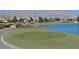 Scenic view of a well-manicured golf course with a lake and mountain backdrop at 2525 Willow Wren Dr, North Las Vegas, NV 89084
