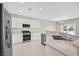 Modern kitchen featuring white cabinetry, granite countertops, and stainless steel appliances for a sleek design at 2525 Willow Wren Dr, North Las Vegas, NV 89084