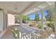 Covered patio boasts an outdoor seating area and a view of the professionally landscaped backyard at 2525 Willow Wren Dr, North Las Vegas, NV 89084