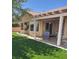 Covered patio with a well-maintained artificial lawn and mature landscape for outdoor enjoyment at 2708 Hope Forest Dr, Las Vegas, NV 89134