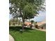Lush backyard featuring well-manicured artificial lawn and manicured landscaping around the perimeter at 2708 Hope Forest Dr, Las Vegas, NV 89134