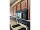 Traditional-style kitchen with warm wood cabinets, black microwave, and light countertops, showcasing a functional cooking space at 2708 Hope Forest Dr, Las Vegas, NV 89134