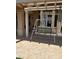 Covered patio featuring textured tile flooring, an overhang with wooden beams, and a peaceful outdoor setting at 2708 Hope Forest Dr, Las Vegas, NV 89134