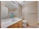Bright bathroom featuring a sink, toilet, mirror, and shower at 2712 Peekskill Ave, Henderson, NV 89052