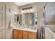 Bright bathroom showcasing a walk-in tub, a sink with cabinet, and neutral tile finishes at 2712 Peekskill Ave, Henderson, NV 89052