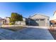 Charming single-story home with a two-car garage, mature tree, and a well-maintained front yard at 2712 Peekskill Ave, Henderson, NV 89052