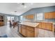 Well-lit kitchen with wood cabinets, large center island, and tiled floor, perfect for cooking and entertaining at 2712 Peekskill Ave, Henderson, NV 89052