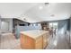 Open-concept kitchen with tile flooring, wood cabinetry, a center island, and an adjacent dining area at 2712 Peekskill Ave, Henderson, NV 89052