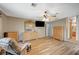 Inviting main bedroom features wood floors, a ceiling fan, and a TV for relaxing after a long day at 2712 Peekskill Ave, Henderson, NV 89052