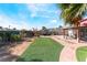 Expansive backyard showcasing artificial turf, brick patio, and covered seating area at 2732 Johannson Ln, Las Vegas, NV 89115
