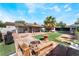 Spacious backyard with patio area, seating, fire pit, and lush greenery at 2732 Johannson Ln, Las Vegas, NV 89115