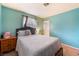 Bedroom featuring aqua walls, double bed, closet and wood furnishings at 2732 Johannson Ln, Las Vegas, NV 89115