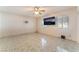 Bedroom with tile flooring, light walls, ceiling fan and mounted television at 2732 Johannson Ln, Las Vegas, NV 89115