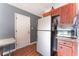 Kitchen featuring stainless steel refrigerator, granite counters and wood cabinets at 2732 Johannson Ln, Las Vegas, NV 89115