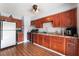 Functional kitchen featuring wood cabinets, stainless steel appliances, and tile flooring at 2732 Johannson Ln, Las Vegas, NV 89115
