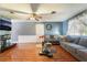 Cozy living room with wood-look tile flooring, ceiling fan, and comfortable seating at 2732 Johannson Ln, Las Vegas, NV 89115