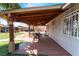 Covered patio with dining set, ceiling fans, and view of the landscaped backyard at 2732 Johannson Ln, Las Vegas, NV 89115